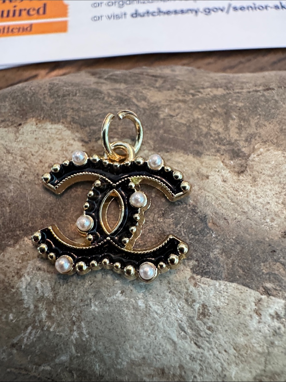 CHANEL Black and Gold Double C Pendant with Pearl Accents